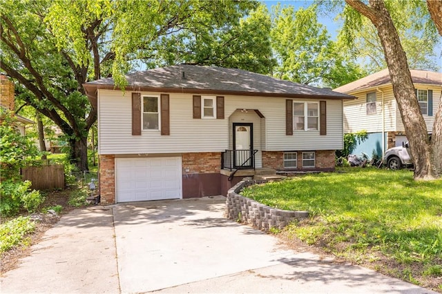 5317 NE 46th St, Kansas City, MO 64117 - raised ranch featuring brick siding, driveway, and a garage