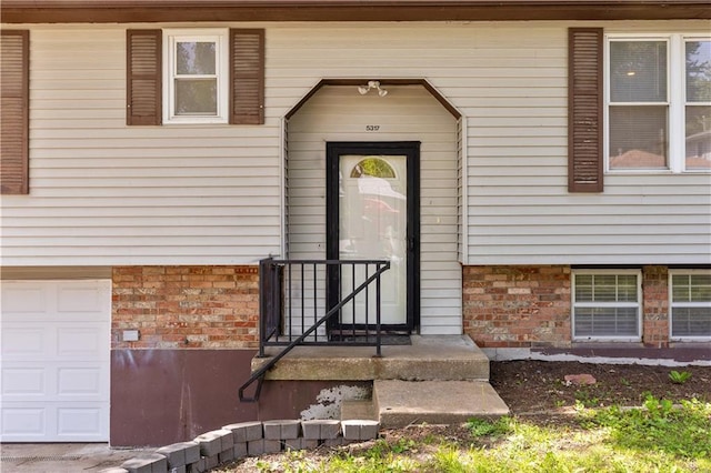 5317 NE 46th St, Kansas City, MO 64117 - doorway to property with a garage and brick siding