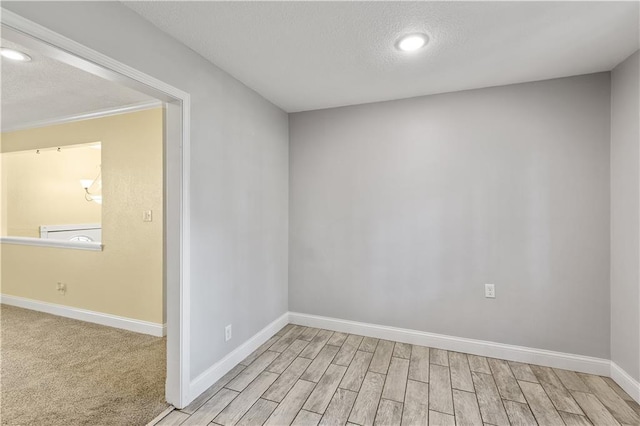5317 NE 46th St, Kansas City, MO 64117 - empty room featuring baseboards, a textured ceiling, light wood-type flooring, and recessed lighting
