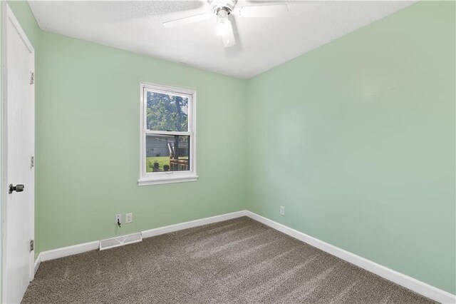 5317 NE 46th St, Kansas City, MO 64117 - unfurnished room featuring a ceiling fan, carpet floors, baseboards, and a textured ceiling