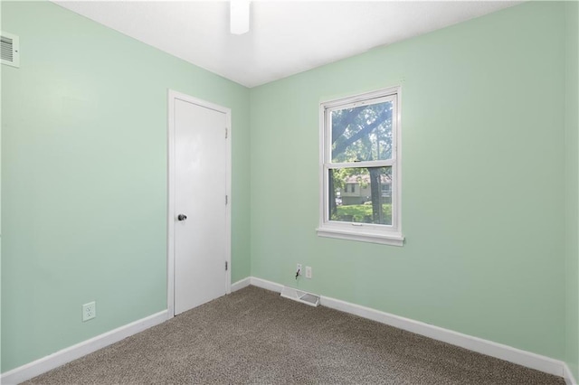 5317 NE 46th St, Kansas City, MO 64117 - empty room featuring dark carpet and baseboards