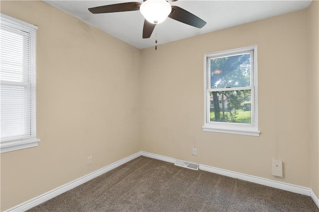 5317 NE 46th St, Kansas City, MO 64117 - unfurnished room featuring dark colored carpet, plenty of natural light, ceiling fan, and baseboards