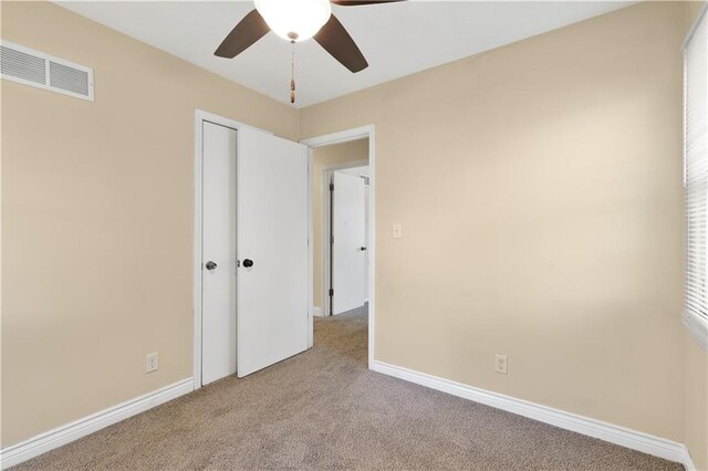 5317 NE 46th St, Kansas City, MO 64117 - unfurnished bedroom with carpet floors, baseboards, a closet, and ceiling fan