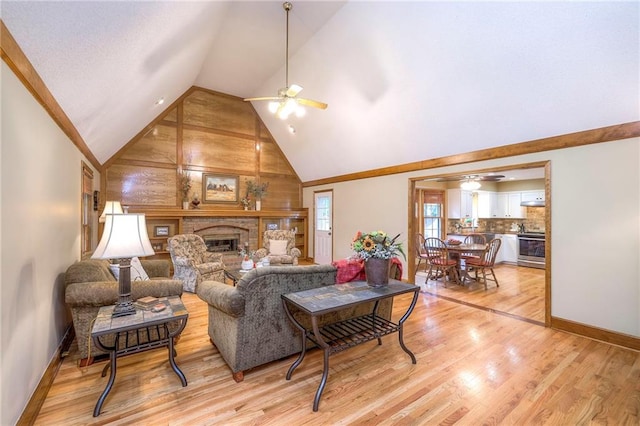 15243 Long St, Overland Park, KS 66221 - living area with ceiling fan, a brick fireplace, wood walls, light wood-type flooring, and baseboards