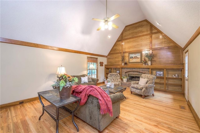 15243 Long St, Overland Park, KS 66221 - living area featuring wood finished floors, a ceiling fan, baseboards, a brick fireplace, and high vaulted ceiling