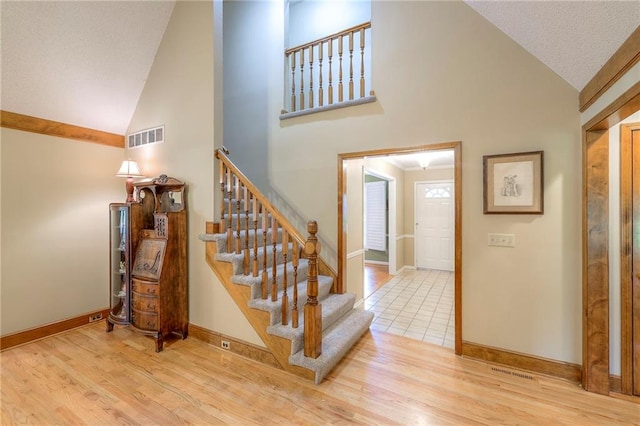 15243 Long St, Overland Park, KS 66221 - stairs featuring high vaulted ceiling, baseboards, and wood finished floors