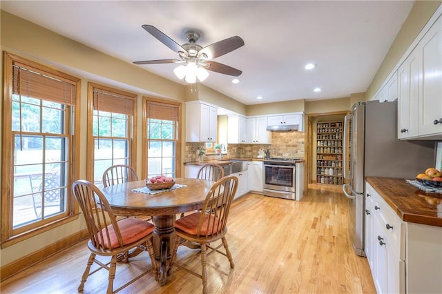15243 Long St, Overland Park, KS 66221 - dining room with plenty of natural light, light wood-type flooring, a ceiling fan, recessed lighting, and baseboards