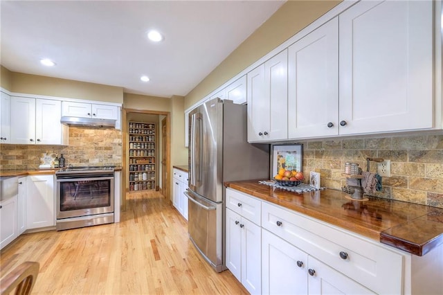 15243 Long St, Overland Park, KS 66221 - kitchen with appliances with stainless steel finishes, under cabinet range hood, white cabinetry, tasteful backsplash, and recessed lighting