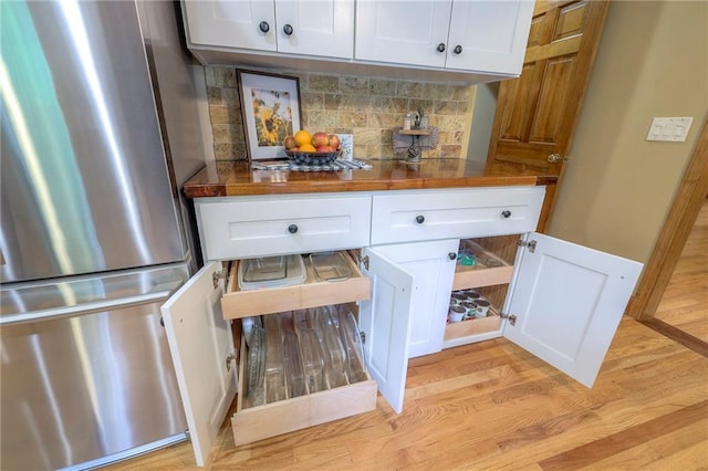 15243 Long St, Overland Park, KS 66221 - bar featuring freestanding refrigerator, light wood-style floors, and backsplash