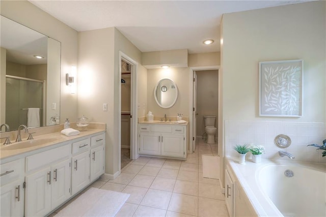 15243 Long St, Overland Park, KS 66221 - full bathroom with tile patterned floors, vanity, a bath, baseboards, and toilet