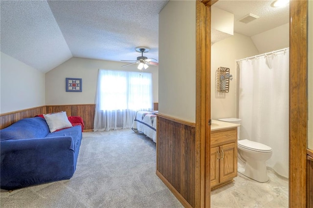 15243 Long St, Overland Park, KS 66221 - interior space with lofted ceiling, a textured ceiling, a wainscoted wall, wood walls, and ceiling fan