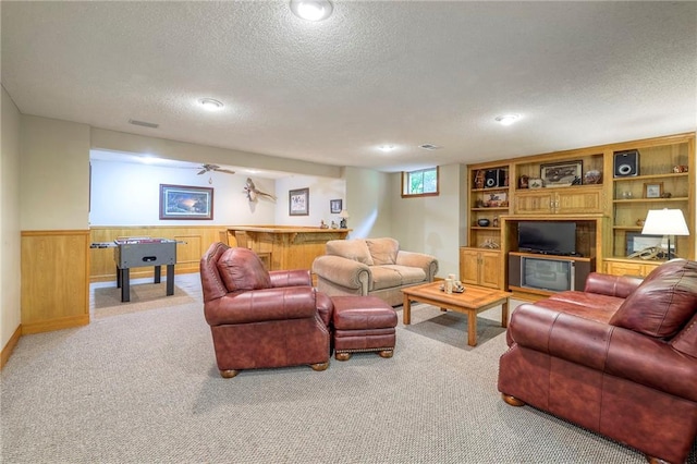 15243 Long St, Overland Park, KS 66221 - living area with a textured ceiling, carpet flooring, wainscoting, a dry bar, and wooden walls