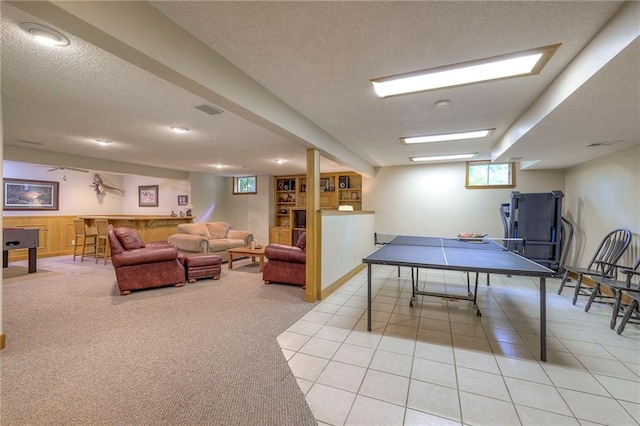 15243 Long St, Overland Park, KS 66221 - rec room with a textured ceiling, light carpet, and light tile patterned flooring
