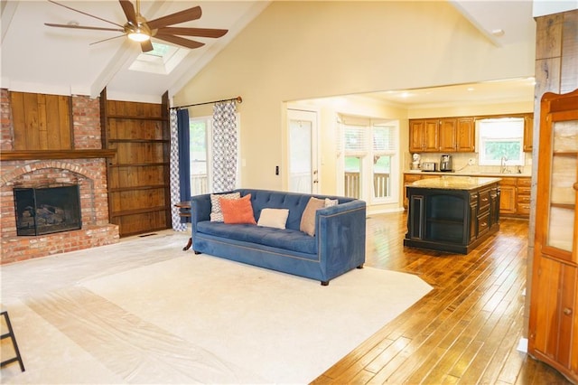 204 NW Redwood Ct, Lees Summit, MO 64064 - living room with ceiling fan, a brick fireplace, healthy amount of natural light, hardwood / wood-style flooring, and high vaulted ceiling