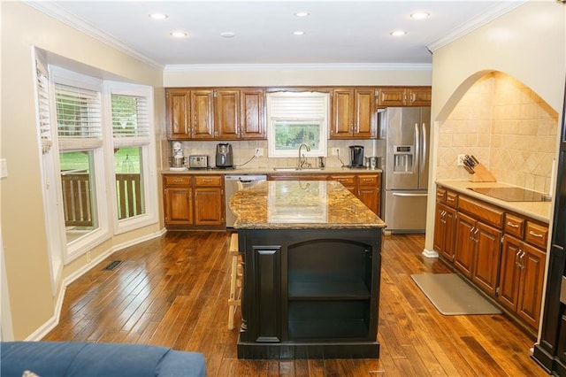 204 NW Redwood Ct, Lees Summit, MO 64064 - kitchen featuring stainless steel appliances, open shelves, light stone counters, brown cabinets, and healthy amount of natural light