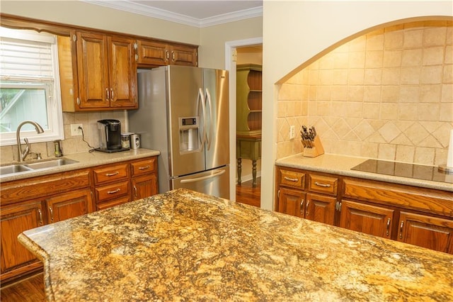 204 NW Redwood Ct, Lees Summit, MO 64064 - kitchen with stainless steel fridge with ice dispenser, black electric cooktop, decorative backsplash, brown cabinets, and crown molding