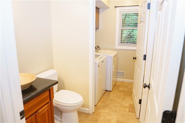 204 NW Redwood Ct, Lees Summit, MO 64064 - bathroom featuring vanity and washing machine and clothes dryer