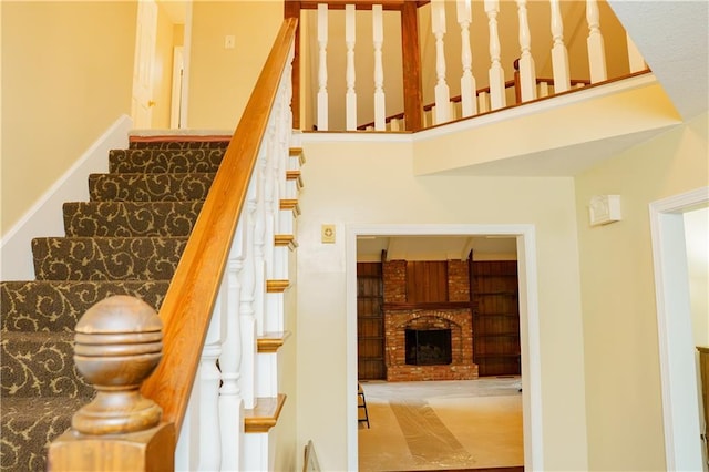 204 NW Redwood Ct, Lees Summit, MO 64064 - stairway featuring a fireplace and a towering ceiling