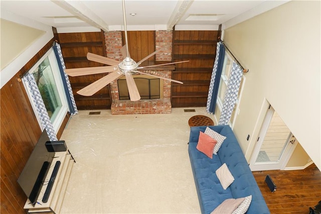 204 NW Redwood Ct, Lees Summit, MO 64064 - unfurnished living room with wood walls, a ceiling fan, and wood finished floors