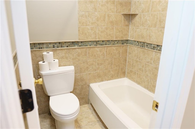 204 NW Redwood Ct, Lees Summit, MO 64064 - full bathroom with tile walls, a bathtub, and tile patterned floors