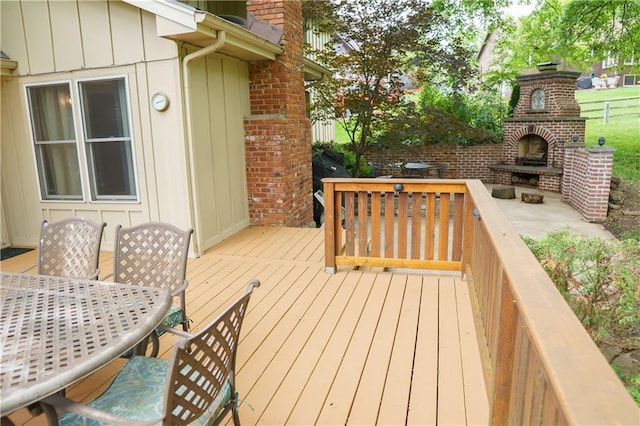 204 NW Redwood Ct, Lees Summit, MO 64064 - wooden deck featuring an outdoor brick fireplace and outdoor dining area