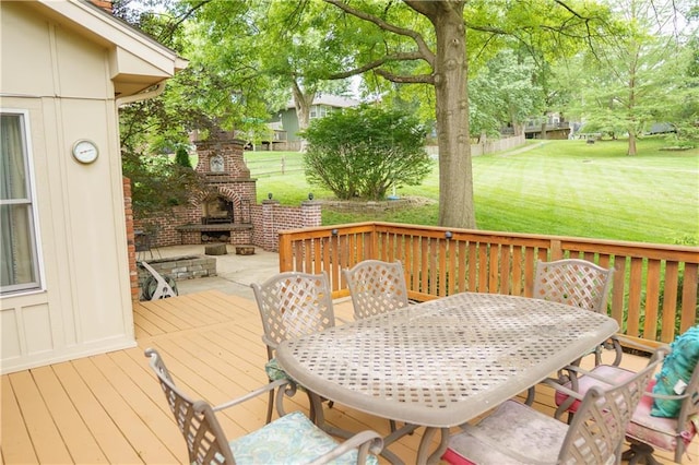204 NW Redwood Ct, Lees Summit, MO 64064 - wooden terrace featuring an outdoor brick fireplace, a lawn, and outdoor dining area