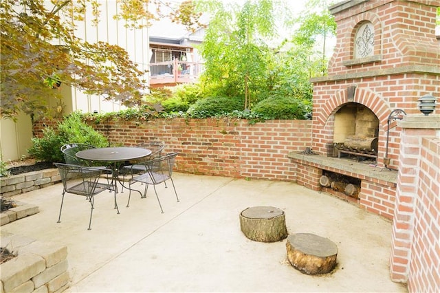 204 NW Redwood Ct, Lees Summit, MO 64064 - view of patio featuring an outdoor brick fireplace and outdoor dining area