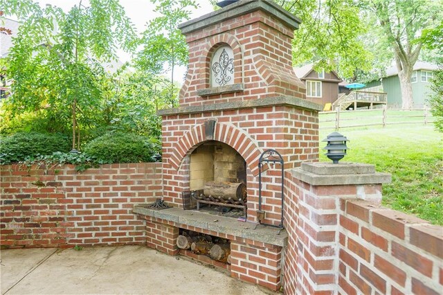 204 NW Redwood Ct, Lees Summit, MO 64064 - view of patio / terrace featuring an outdoor brick fireplace