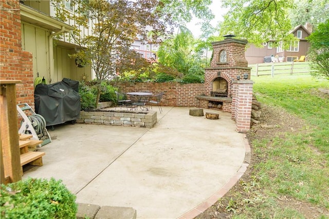 204 NW Redwood Ct, Lees Summit, MO 64064 - view of patio / terrace with an outdoor brick fireplace and a grill