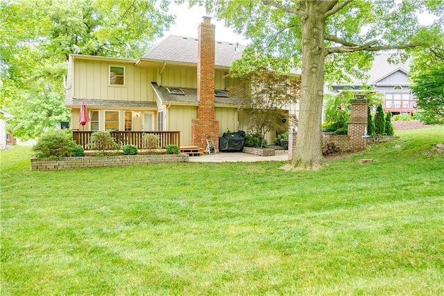 204 NW Redwood Ct, Lees Summit, MO 64064 - rear view of property featuring board and batten siding, a chimney, a yard, and a wooden deck