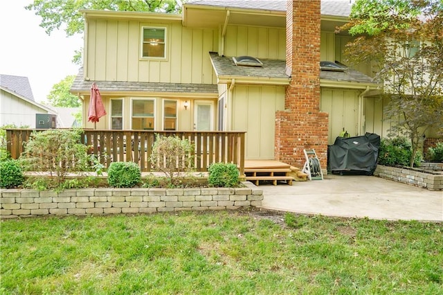 204 NW Redwood Ct, Lees Summit, MO 64064 - rear view of property with a patio, a yard, a chimney, a wooden deck, and roof with shingles