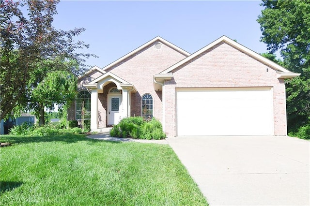2404 Edmonds Ct, Columbia, MO 65203 - view of front of home featuring a garage, brick siding, and driveway