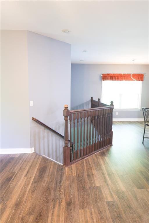 2404 Edmonds Ct, Columbia, MO 65203 - hallway featuring an upstairs landing, wood finished floors, and baseboards