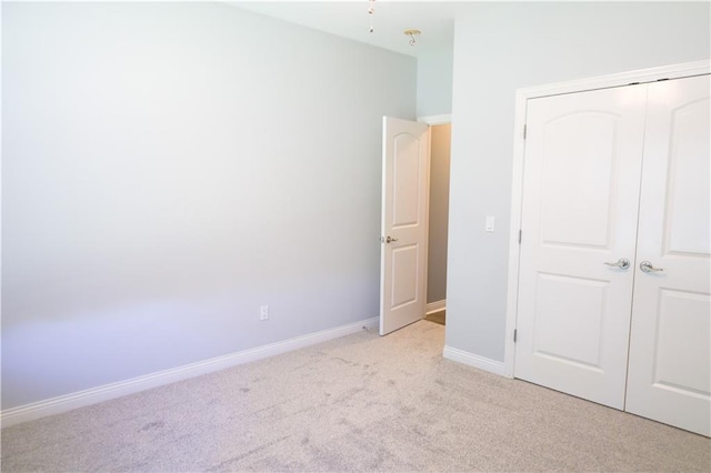 2404 Edmonds Ct, Columbia, MO 65203 - unfurnished bedroom featuring light carpet, a closet, and baseboards