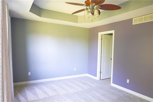 2404 Edmonds Ct, Columbia, MO 65203 - empty room featuring ceiling fan, carpet floors, baseboards, and a tray ceiling