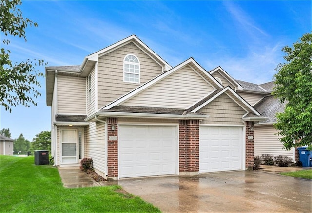 900 SW Peach Tree Ln, Blue Springs, MO 64064 - traditional home with driveway, brick siding, a front yard, and roof with shingles