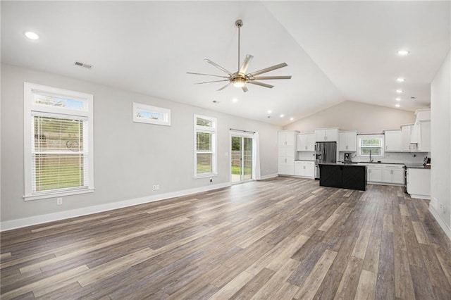 151 SE 225th Rd, Warrensburg, MO 64093 - unfurnished living room with ceiling fan, wood finished floors, plenty of natural light, vaulted ceiling, and recessed lighting