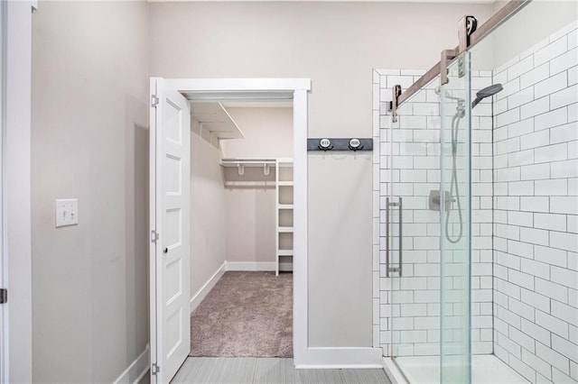 151 SE 225th Rd, Warrensburg, MO 64093 - bathroom with a shower stall, a spacious closet, and baseboards