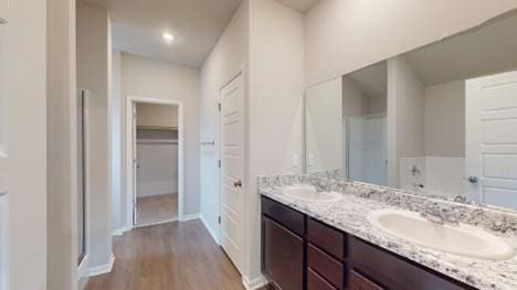 575 W Lanesfield St, Gardner, KS 66030 - bathroom featuring double vanity, wood finished floors, and an enclosed shower