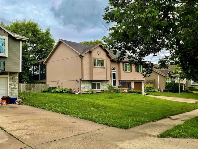11601 N Manning Ave, Kansas City, MO 64157 - bi-level home with an attached garage, driveway, stone siding, and cooling unit