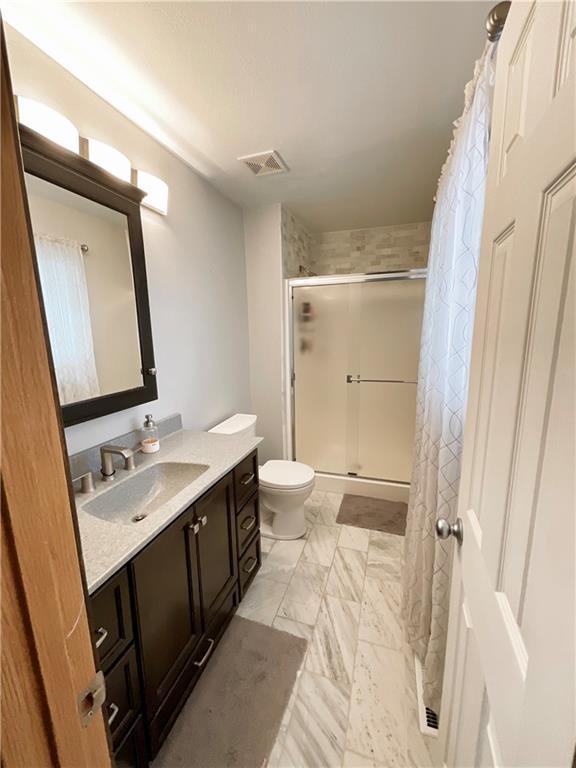 11601 N Manning Ave, Kansas City, MO 64157 - full bath with vanity, a shower stall, toilet, and marble finish floors