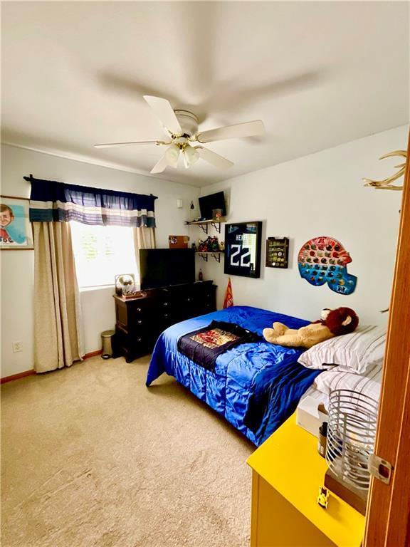 11601 N Manning Ave, Kansas City, MO 64157 - carpeted bedroom with a ceiling fan