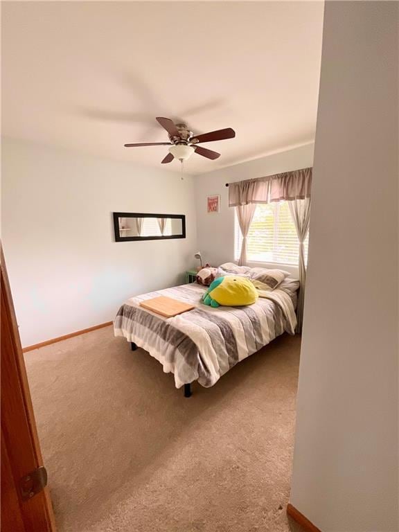 11601 N Manning Ave, Kansas City, MO 64157 - bedroom with carpet flooring, baseboards, and a ceiling fan