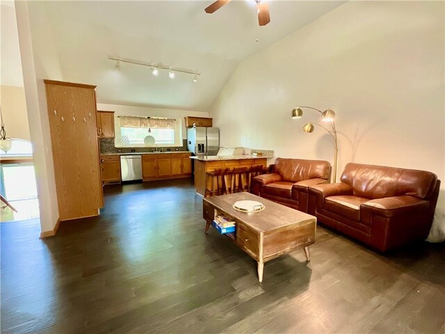 11601 N Manning Ave, Kansas City, MO 64157 - living room with rail lighting, dark wood-type flooring, vaulted ceiling, and ceiling fan