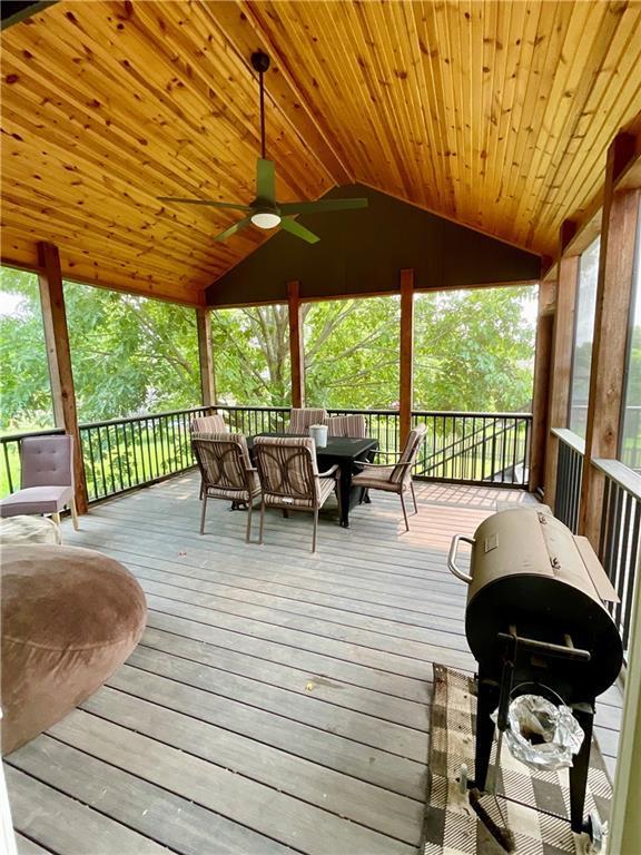 11601 N Manning Ave, Kansas City, MO 64157 - deck featuring a grill, ceiling fan, and outdoor dining area