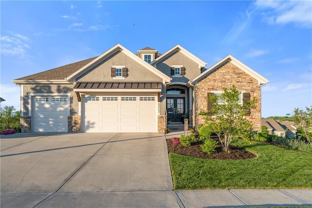 4313 Lakeview Ter, Basehor, KS 66007 - view of front of house featuring stone siding, french doors, driveway, an attached garage, and stucco siding