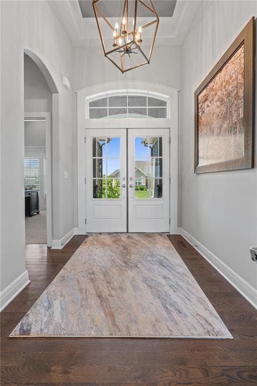 4313 Lakeview Ter, Basehor, KS 66007 - foyer entrance with arched walkways, french doors, dark wood-style flooring, a high ceiling, and baseboards