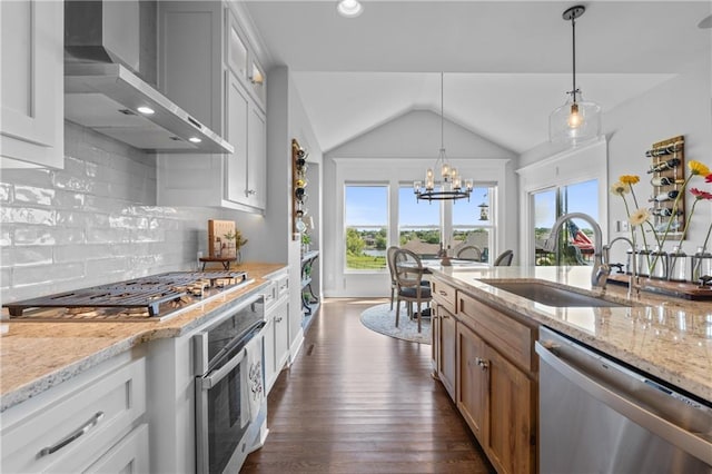 4313 Lakeview Ter, Basehor, KS 66007 - kitchen featuring appliances with stainless steel finishes, wall chimney range hood, a sink, vaulted ceiling, and a chandelier