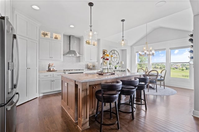 4313 Lakeview Ter, Basehor, KS 66007 - kitchen featuring wall chimney range hood, stainless steel fridge with ice dispenser, vaulted ceiling, backsplash, and dark wood-type flooring