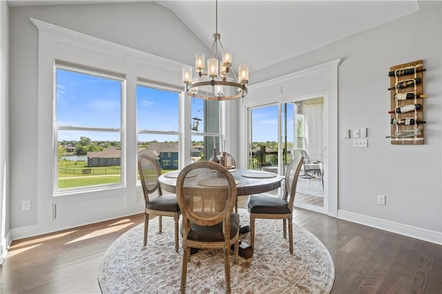 4313 Lakeview Ter, Basehor, KS 66007 - dining area featuring a chandelier, dark wood-style floors, lofted ceiling, and baseboards